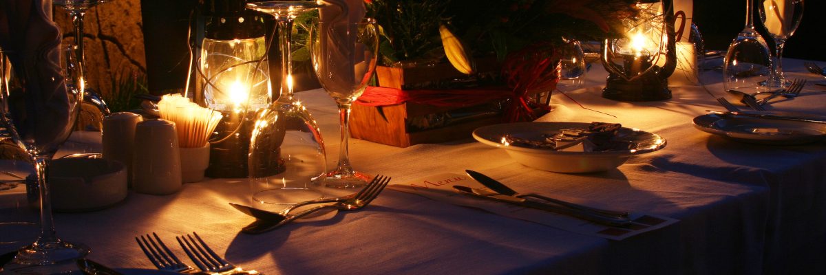 Romantic outdoor dinner with lanterns.